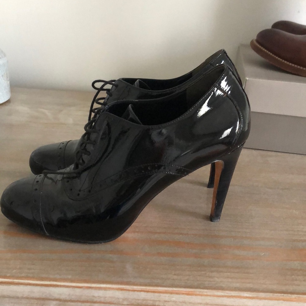 High heeled patent wingtip boots
